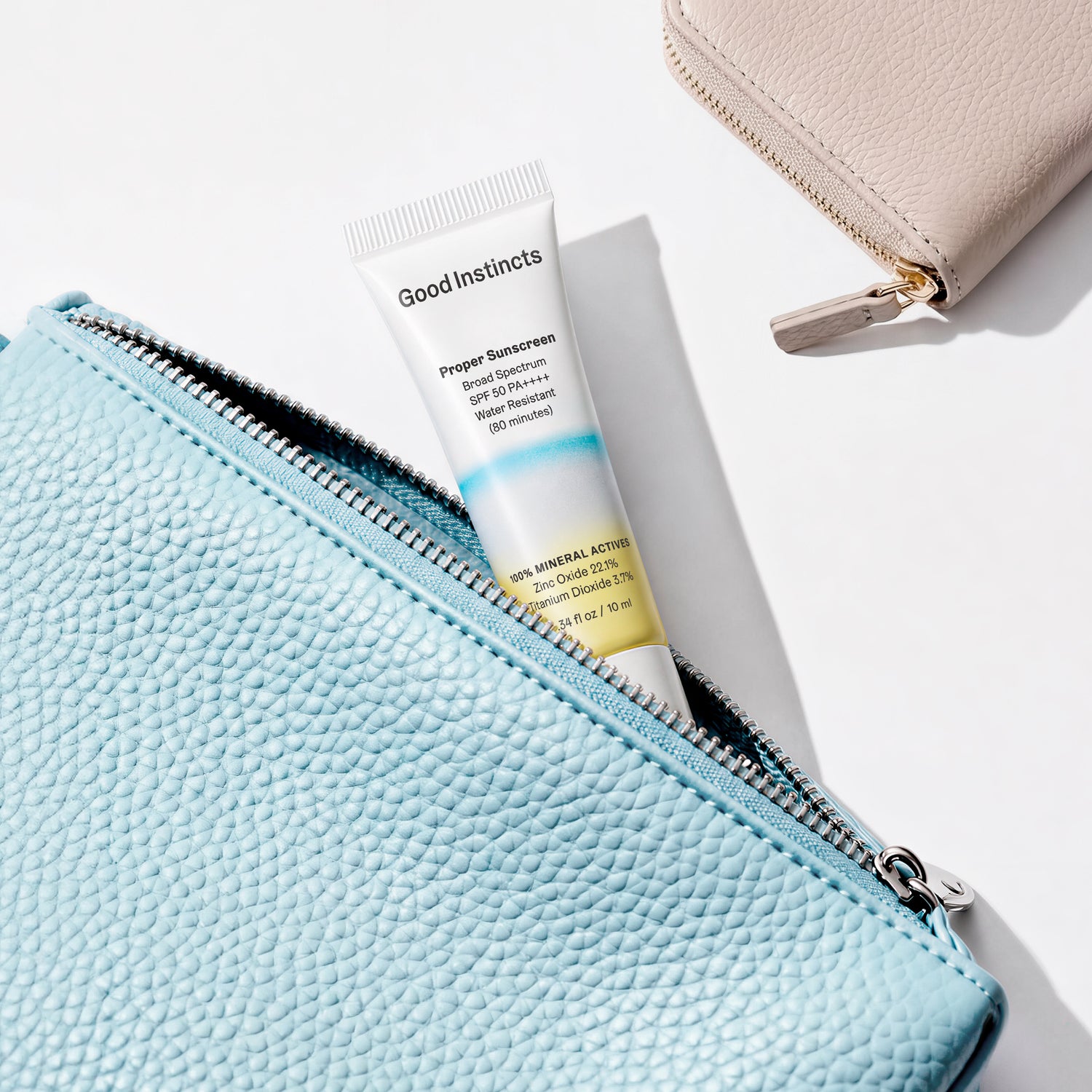 Good Instincts sunscreen tube inside a blue pouch on a white background