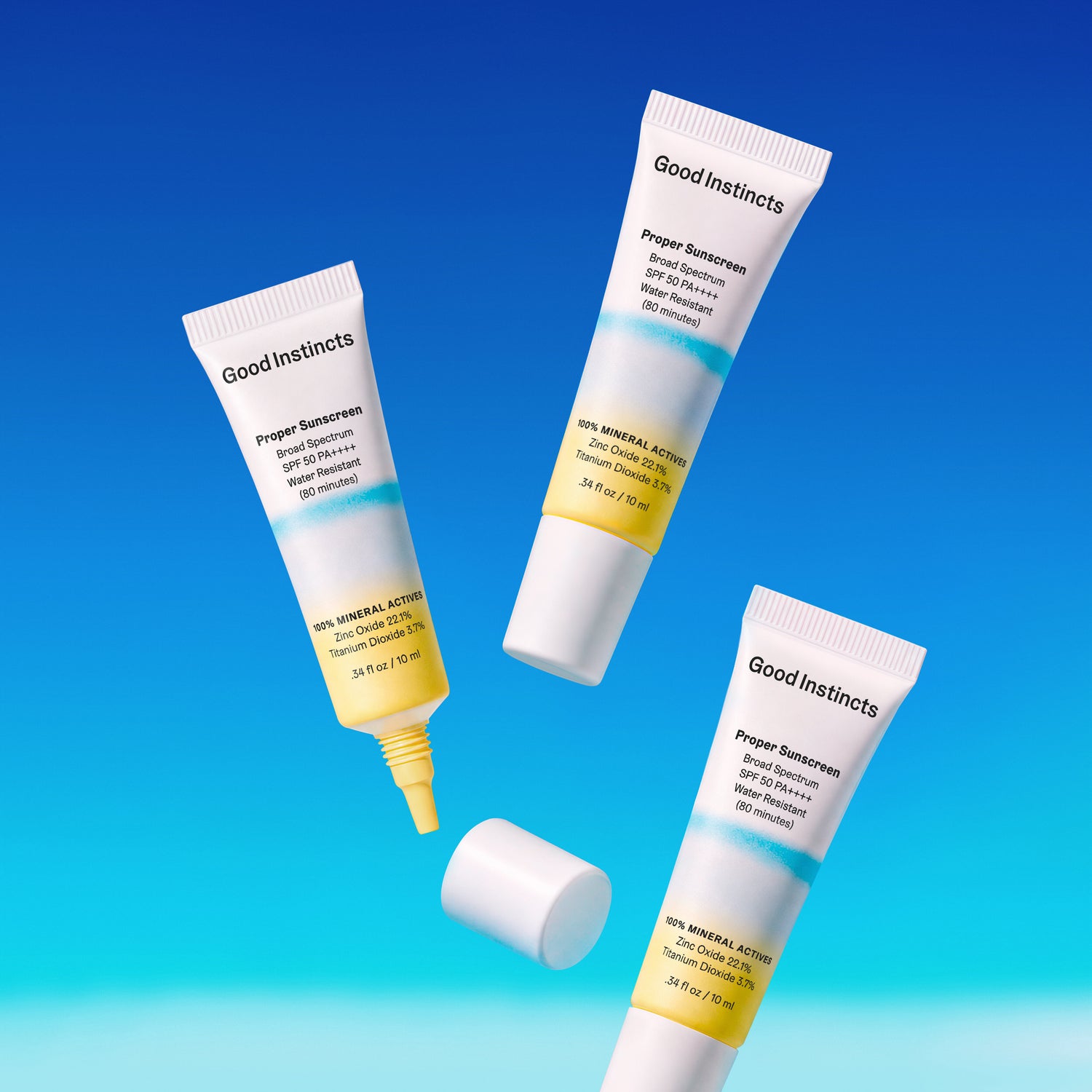 Three tubes of Good Instincts sunscreen on a gradient blue background